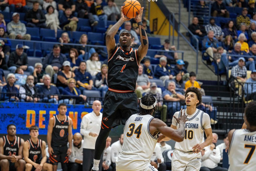 Dec 6, 2025; Berkeley, California, USA; Pacific Tigers guard Justin Rochelin (1) shoots the basketball over California Golden Bears forward Lee Dort (34) during the second half at Haas Pavilion. Mandatory Credit: Neville E. Guard-Imagn Images