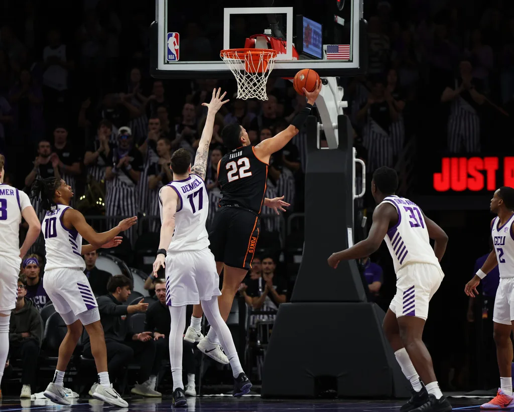 Dec 6, 2025; Phoenix, Arizona, USA; Oklahoma State Cowboys forward Parsa Fallah (22) makes a layup against the Grand Canyon Lopes at PHX Arena. Mandatory Credit: Anna Carrington-Imagn Images