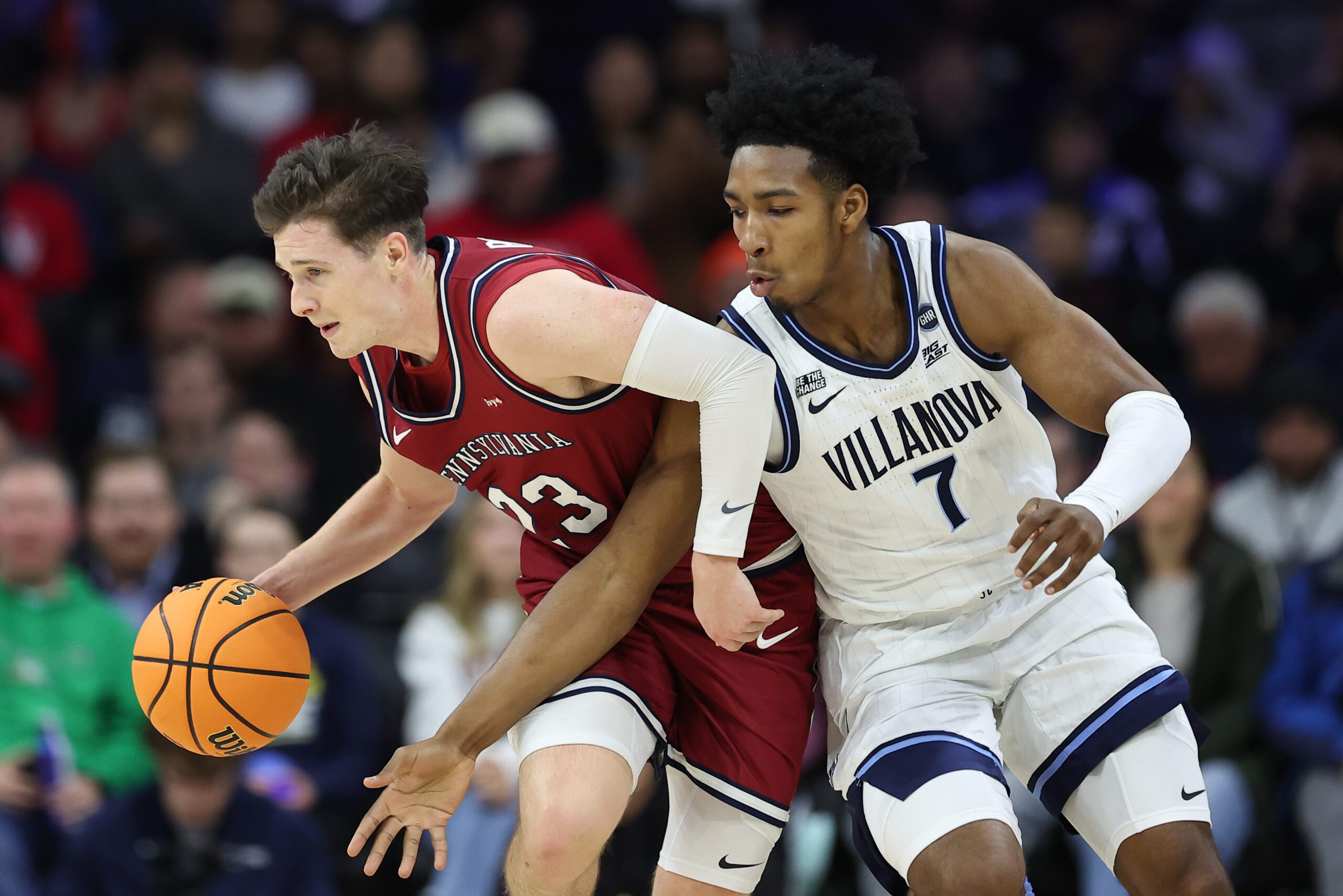 Dec 6, 2025; Philadelphia, PA, USA; Penn Quakers forward Ethan Roberts (23) controls the ball against Villanova Wildcats guard Malachi Palmer (7) during the first half at Xfinity Mobile Arena. Mandatory Credit: Bill Streicher-Imagn Images