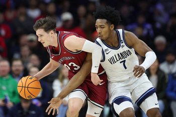 Dec 6, 2025; Philadelphia, PA, USA; Penn Quakers forward Ethan Roberts (23) controls the ball against Villanova Wildcats guard Malachi Palmer (7) during the first half at Xfinity Mobile Arena. Mandatory Credit: Bill Streicher-Imagn Images