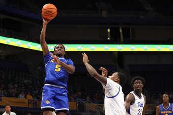 Dec 7, 2025; Pittsburgh, Pennsylvania, USA;  Hofstra Pride guard Cruz Davis (5) shoots over Pittsburgh Panthers guard Damarco Minor (right) during the first half against at the Petersen Events Center. Mandatory Credit: Charles LeClaire-Imagn Images