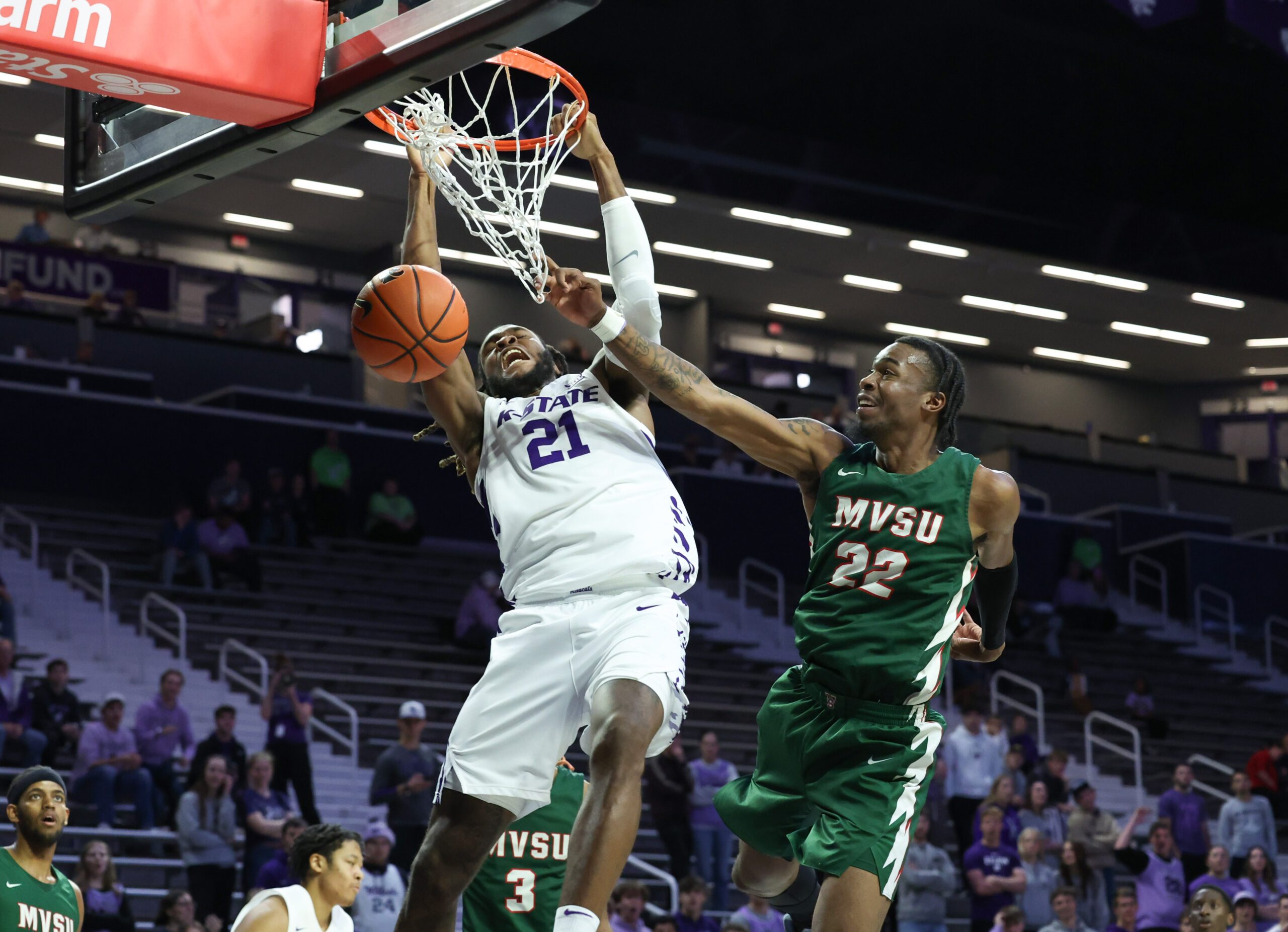 Dec 8, 2025; Manhattan, Kansas, USA; Kansas State Wildcats forward Khamari McGriff (21) dunks the ball against Mississippi Valley State Delta Devils forward Daniel Mayfield (22) during the second half at Bramlage Coliseum. Mandatory Credit: Scott Sewell-Imagn Images
