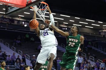 Dec 8, 2025; Manhattan, Kansas, USA; Kansas State Wildcats forward Khamari McGriff (21) dunks the ball against Mississippi Valley State Delta Devils forward Daniel Mayfield (22) during the second half at Bramlage Coliseum. Mandatory Credit: Scott Sewell-Imagn Images