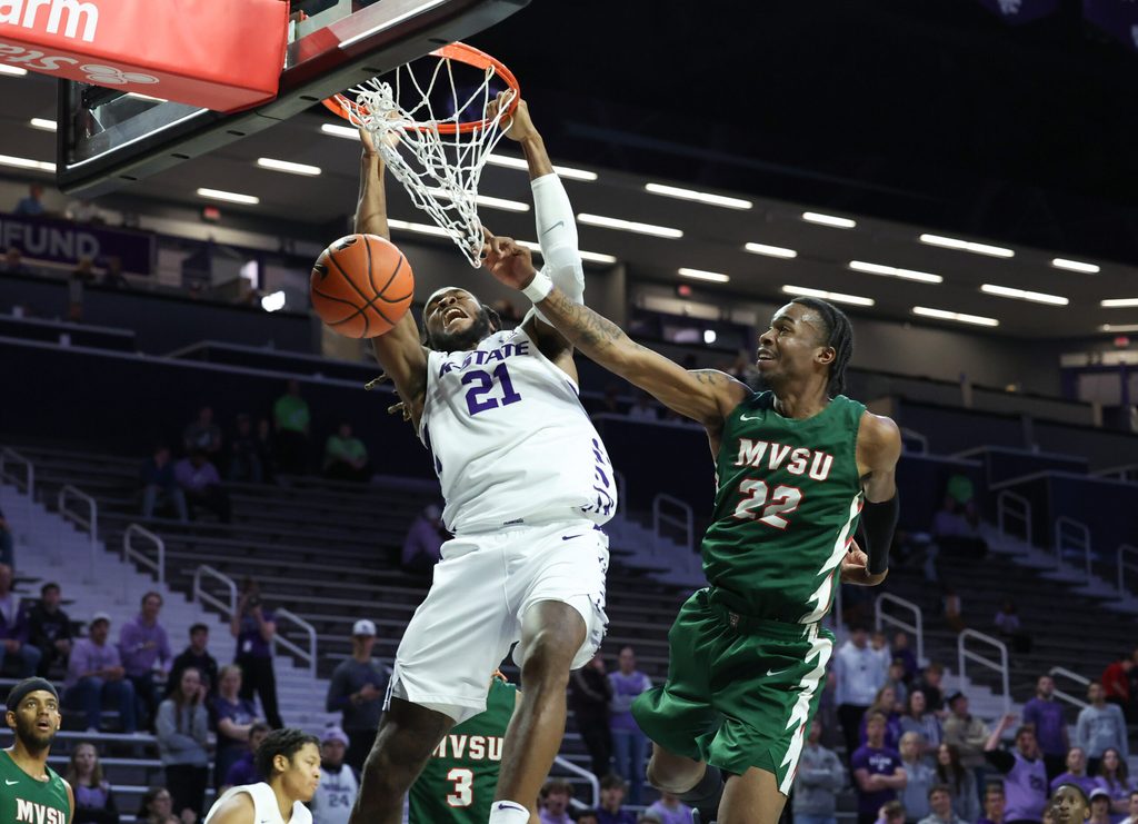 Dec 8, 2025; Manhattan, Kansas, USA; Kansas State Wildcats forward Khamari McGriff (21) dunks the ball against Mississippi Valley State Delta Devils forward Daniel Mayfield (22) during the second half at Bramlage Coliseum. Mandatory Credit: Scott Sewell-Imagn Images