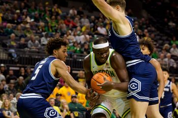 Oregon center Ege Demir looks for room to move under cover from UC Davis guard Jalen Stokes, left, and UC Davis forward Niko Rocak as the Oregon Ducks host the UC Davis Aggies on Dec. 13, 2025, at Matthew Knight Arena in Eugene, Oregon.