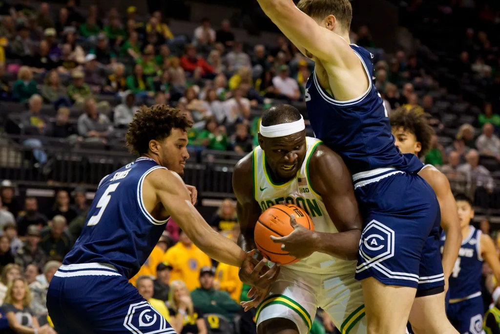 Oregon center Ege Demir looks for room to move under cover from UC Davis guard Jalen Stokes, left, and UC Davis forward Niko Rocak as the Oregon Ducks host the UC Davis Aggies on Dec. 13, 2025, at Matthew Knight Arena in Eugene, Oregon.
