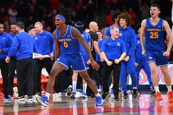 Dec 13, 2025; Syracuse, New York, USA; Hofstra Pride guard Biggie Patterson (0) and the bench react to winning a game against the Syracuse Orange at the JMA Wireless Dome. Mandatory Credit: Mark Konezny-Imagn Images