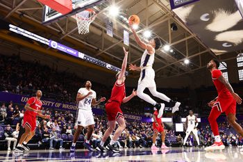 Dec 13, 2025; Seattle, Washington, USA; Washington Huskies guard Desmond Claude (1) shoots a lay up while defended by Southern Utah Thunderbirds forward Jaiden Feroah (35) in the first half at Alaska Airlines Arena at Hec Edmundson Pavilion. Mandatory Credit: Kevin Ng-Imagn Images