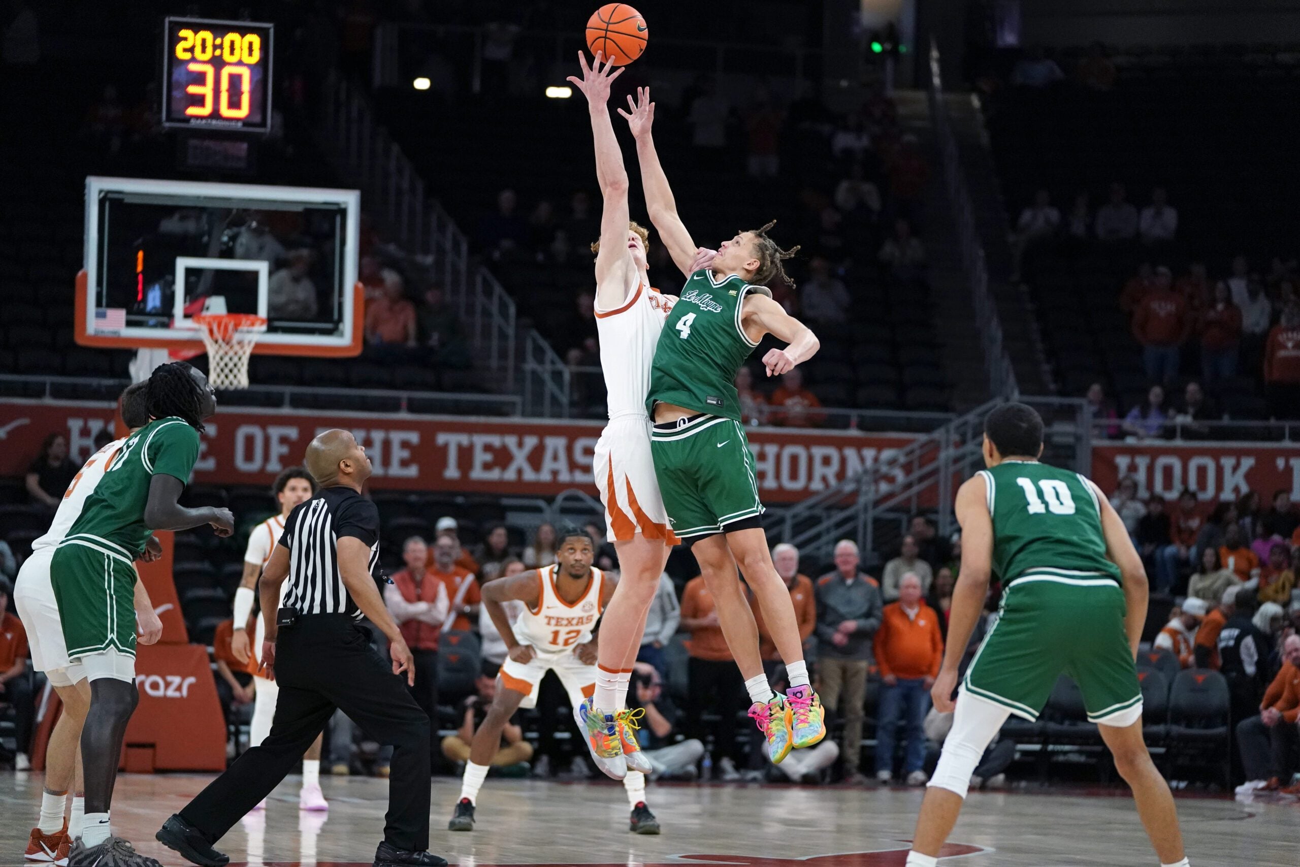 Dec 16, 2025; Austin, Texas, USA; Texas Longhorns center Matas Vokietaitis (8) gets control of the tip off against Le Moyne Dolphins forward Shilo Jackson (4) during the first half at Moody Center. Mandatory Credit: Dustin Safranek-Imagn Images