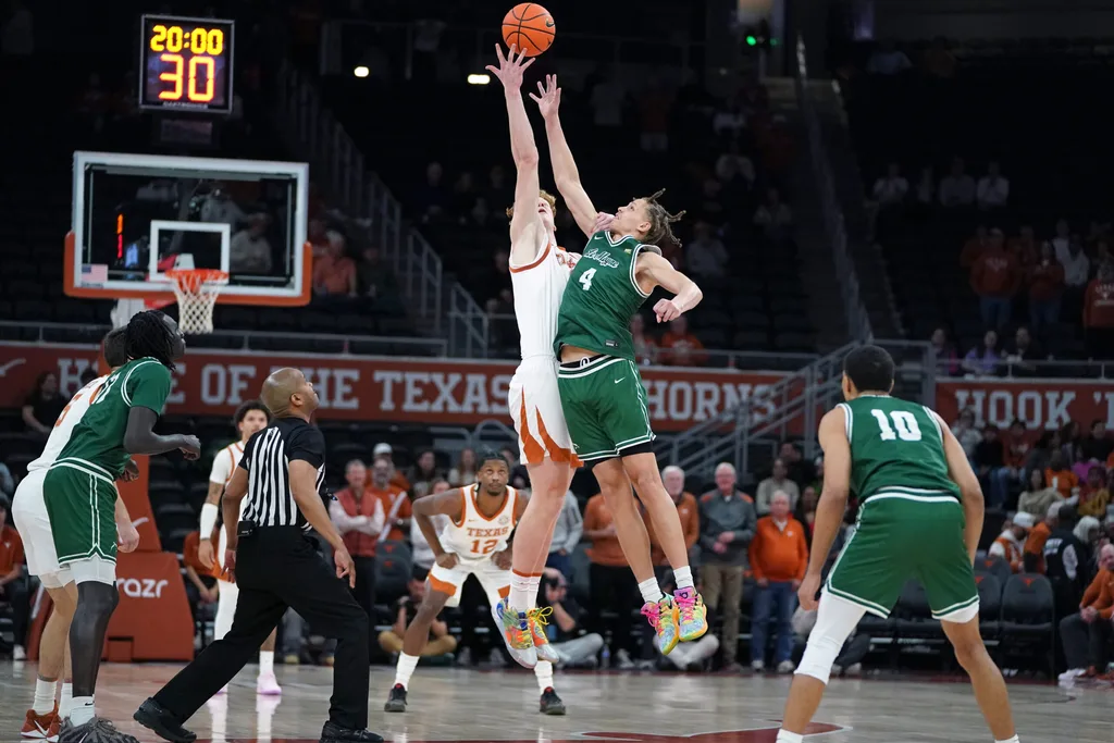 Dec 16, 2025; Austin, Texas, USA; Texas Longhorns center Matas Vokietaitis (8) gets control of the tip off against Le Moyne Dolphins forward Shilo Jackson (4) during the first half at Moody Center. Mandatory Credit: Dustin Safranek-Imagn Images