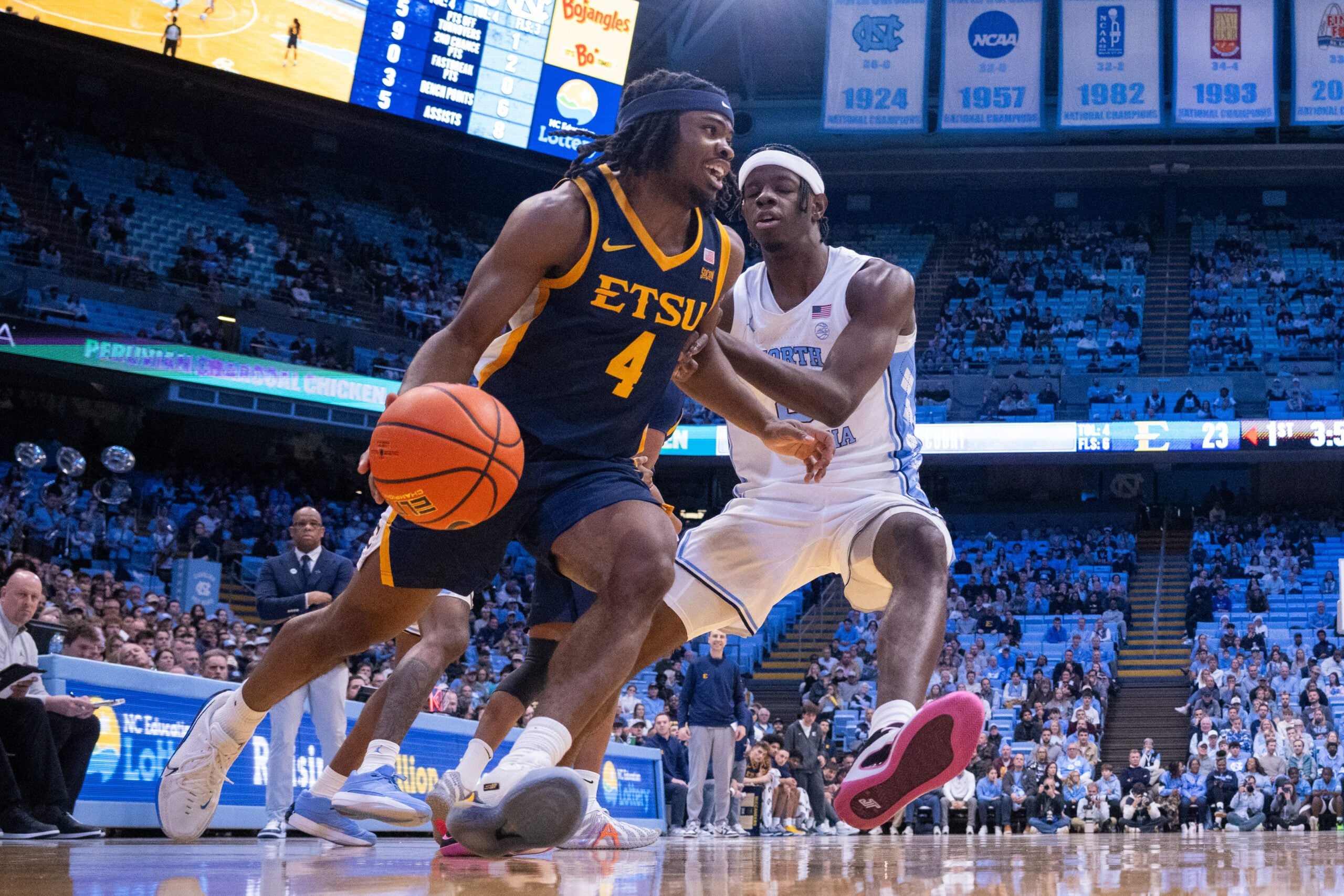 Dec 16, 2025; Chapel Hill, North Carolina, USA; ETSU Buccaneers guard Jaylen Smith (4) drives on North Carolina Tar Heels forward Caleb Wilson (8) during the first half at Dean E. Smith Center. Mandatory Credit: Scott Kinser-Imagn Images