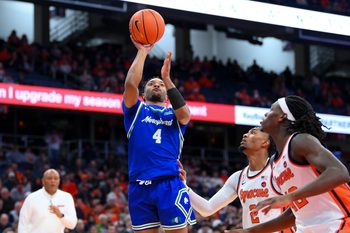 Dec 17, 2025; Syracuse, New York, USA; Mercyhurst Lakers guard Bernie Blunt (4) shoots against Syracuse Orange guard J.J. Starling (2) and forward William Kyle III (42) during the first half at the JMA Wireless Dome. Mandatory Credit: Rich Barnes-Imagn Images