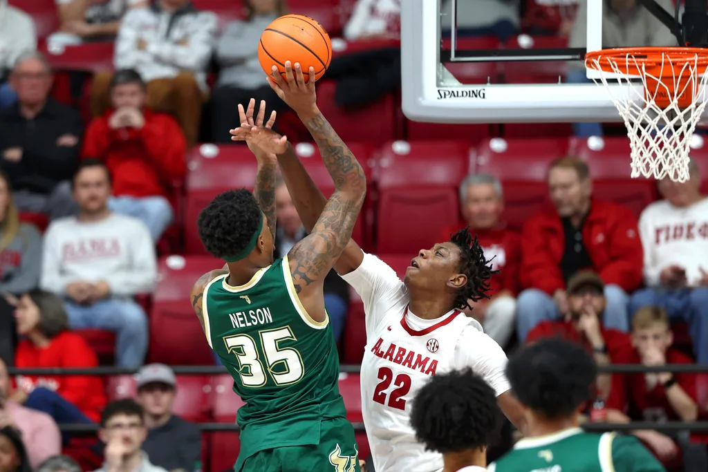 Dec 17, 2025; Tuscaloosa, Alabama, USA; Alabama Crimson Tide forward Aiden Sherrell (22) blocks South Florida Bulls forward Izaiyah Nelson (35) during the first half at Coleman Coliseum. Mandatory Credit: David Leong-Imagn Images
