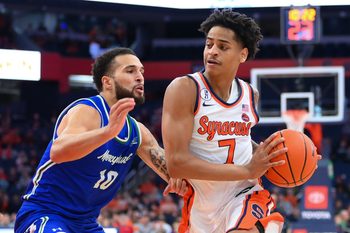 Dec 17, 2025; Syracuse, New York, USA; Syracuse Orange guard Kiyan Anthony (7) drives against Mercyhurst Lakers guard Christian Gamble (10) during the second half at the JMA Wireless Dome. Mandatory Credit: Rich Barnes-Imagn Images