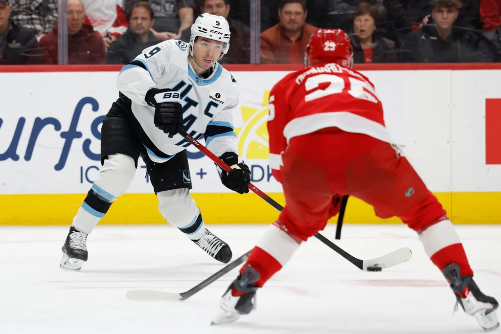 Dec 17, 2025; Detroit, Michigan, USA; Utah Mammoth right wing Clayton Keller (9) skates with the puck defended by Detroit Red Wings defenseman Jacob Bernard-Docker (25) in the third period at Little Caesars Arena. Mandatory Credit: Rick Osentoski-Imagn Images