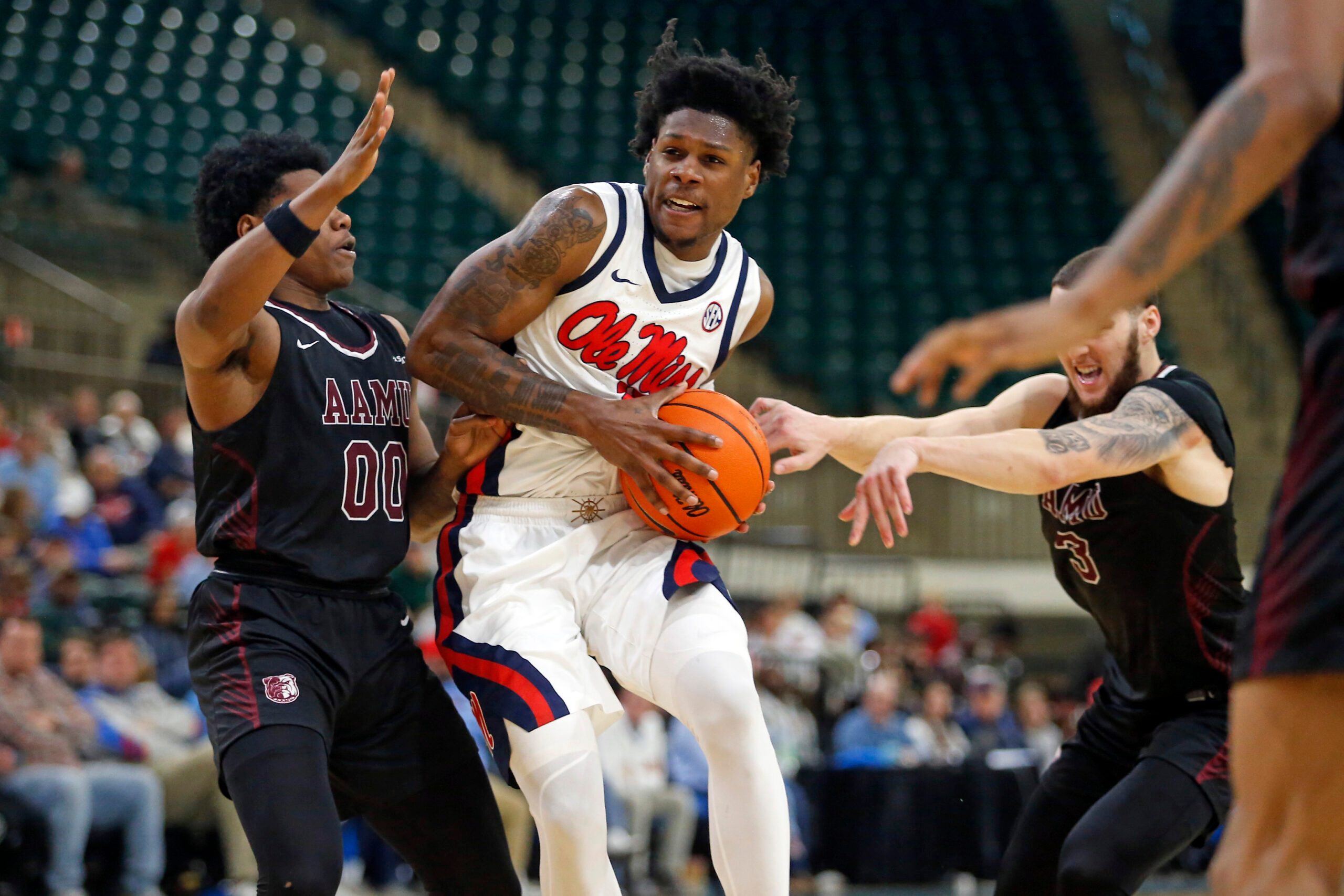 Dec 17, 2025; Tupelo, Mississippi, USA; Mississippi Rebels guard AJ Storr (2) drives to the basket as Alabama A&M Bulldogs guard Kintavious Dozier (00) defends during the second half at Cadence Bank Arena. Mandatory Credit: Petre Thomas-Imagn Images