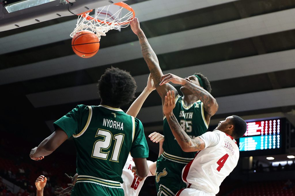 Dec 17, 2025; Tuscaloosa, Alabama, USA; South Florida Bulls forward Izaiyah Nelson (35) puts back a rebound against Alabama Crimson Tide center Noah Williamson (15) and guard Davion Hannah (4) during the second half at Coleman Coliseum. Mandatory Credit: David Leong-Imagn Images
