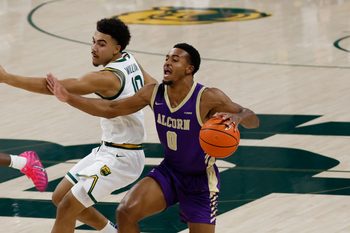 Dec 19, 2025; Waco, Texas, USA;  Alcorn State Braves guard Shane Lancaster (0) dribbles past Baylor Bears guard Isaac Williams (10) during the first half at Paul and Alejandra Foster Pavilion. Mandatory Credit: Chris Jones-Imagn Images