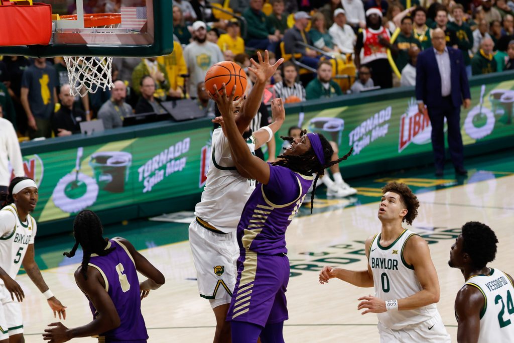 Dec 19, 2025; Waco, Texas, USA; Alcorn State Braves guard Omari Hamilton (12) scores a layup against Baylor Bears center Caden Powell (44) during the first half at Paul and Alejandra Foster Pavilion. Mandatory Credit: Chris Jones-Imagn Images
