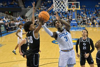 Dec 19, 2025; Los Angeles, California, USA; UCLA Bruins guard Eric Dailey Jr. (3) is defended by Cal Poly Mustangs guard Hamad Mousa (10) as he goes up for a basket during the first half at Pauley Pavilion presented by Wescom Financial. Mandatory Credit: Jayne Kamin-Oncea-Imagn Images
