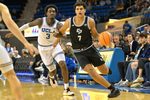 Dec 19, 2025; Los Angeles, California, USA;Cal Poly Mustangs forward Ali Assran (7) drives past UCLA Bruins guard Eric Dailey Jr. (3) during the second half at Pauley Pavilion presented by Wescom Financial. Mandatory Credit: Jayne Kamin-Oncea-Imagn Images