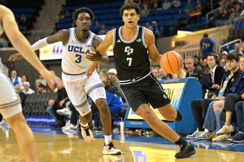 Dec 19, 2025; Los Angeles, California, USA;Cal Poly Mustangs forward Ali Assran (7) drives past UCLA Bruins guard Eric Dailey Jr. (3) during the second half at Pauley Pavilion presented by Wescom Financial. Mandatory Credit: Jayne Kamin-Oncea-Imagn Images
