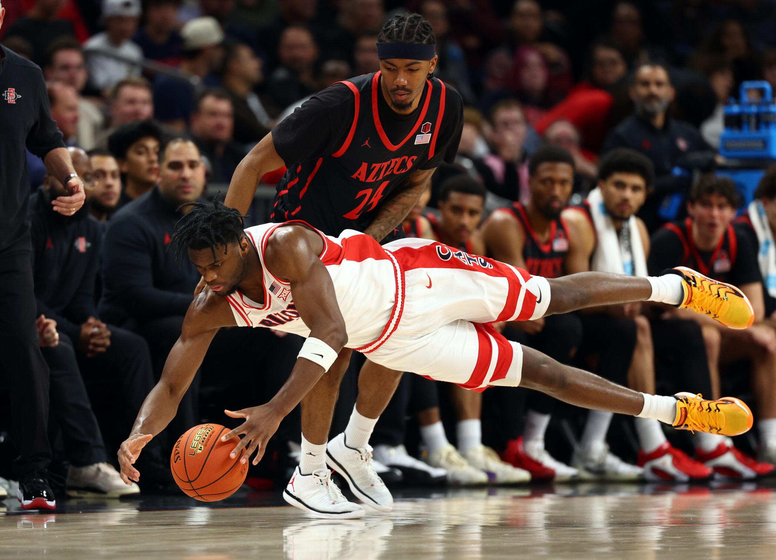 Dec 20, 2025; Phoenix, Arizona, USA; Arizona Wildcats forward Dwayne Aristode (2) dives for a loose ball against San Diego State Aztecs guard Taj DeGourville (24) in the second half during the Hall of Fame Series at Mortgage Matchup Center. Mandatory Credit: Mark J. Rebilas-Imagn Images
