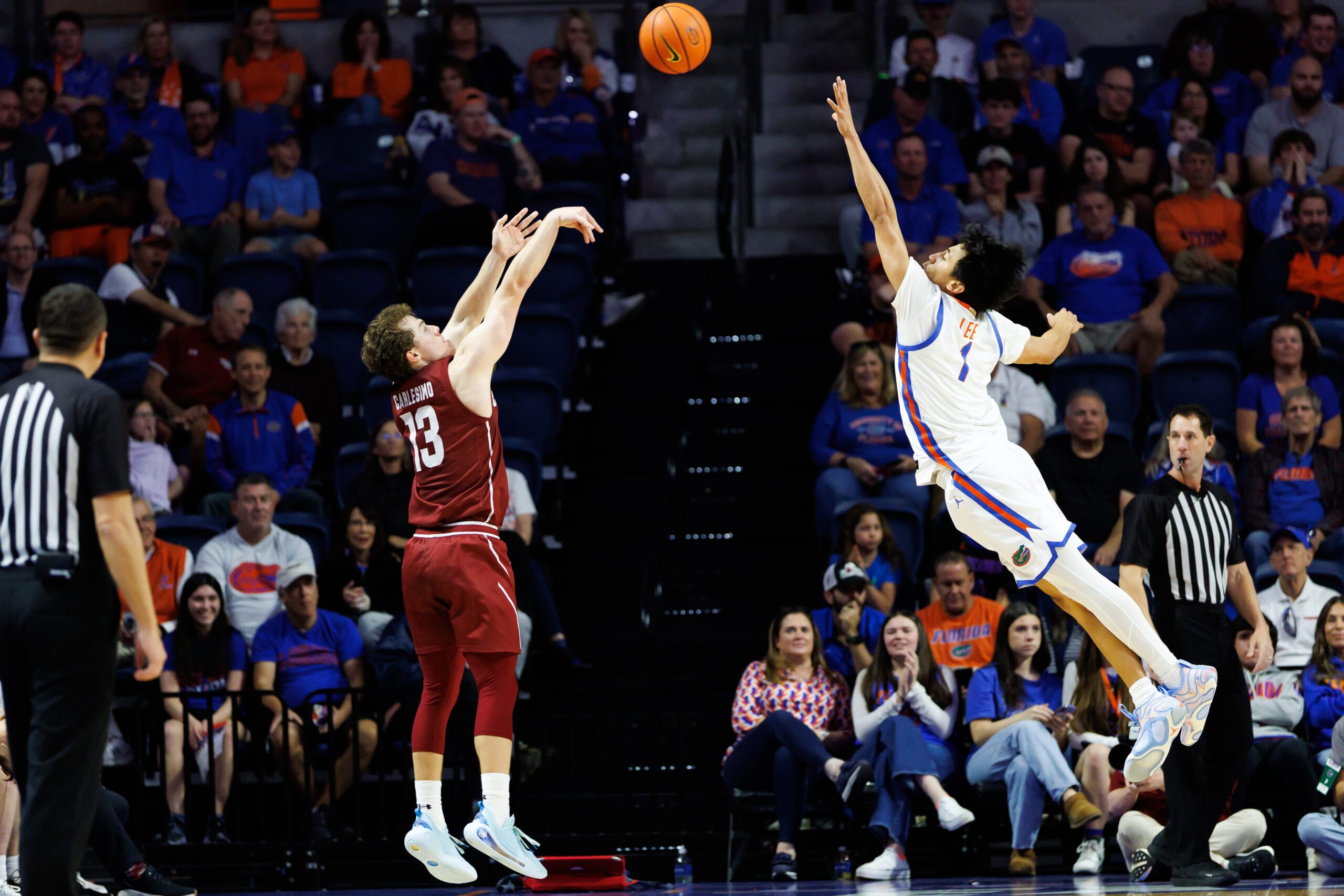 Dec 21, 2025; Gainesville, Florida, USA; Colgate Raiders guard Kyle Carlesimo (13) shoots over Florida Gators guard Xaivian Lee (1) during the second half at Exactech Arena at the Stephen C. O'Connell Center. Mandatory Credit: Matt Pendleton-Imagn Images