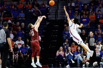 Dec 21, 2025; Gainesville, Florida, USA; Colgate Raiders guard Kyle Carlesimo (13) shoots over Florida Gators guard Xaivian Lee (1) during the second half at Exactech Arena at the Stephen C. O'Connell Center. Mandatory Credit: Matt Pendleton-Imagn Images