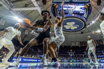 Dec 21, 2025; South Bend, Indiana, USA; Notre Dame Fighting Irish forward Kebba Njie (14) looks to pass as Purdue Fort Wayne Mastodons forward Darius Duffy (34) defends him during the second half at Purcell Pavilion at the Joyce Center. Mandatory Credit: Michael Caterina-Imagn Images