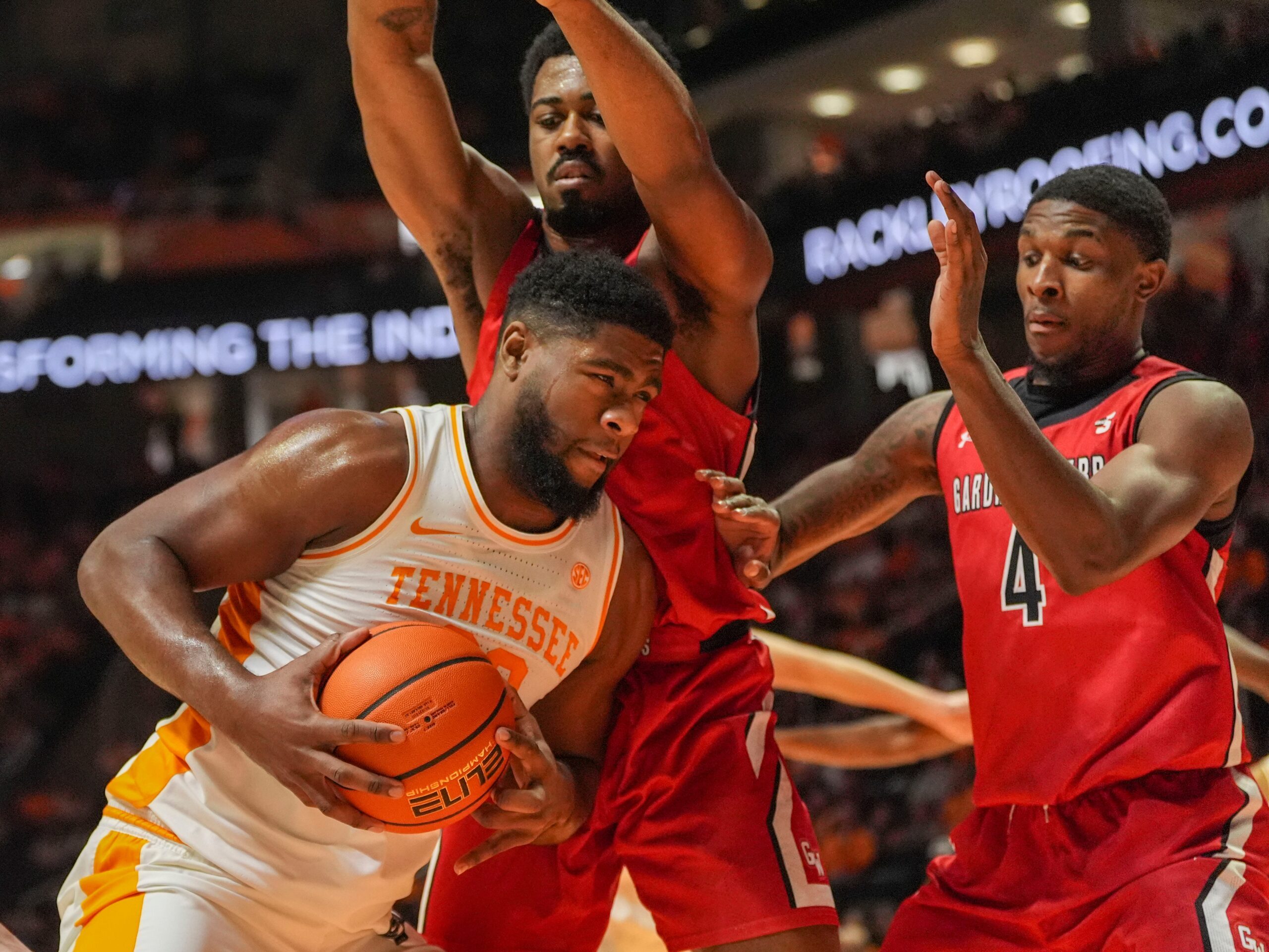 Tennessee forward Jaylen Carey (23) waits for an opportunity to shoot while guarded by Gardner-Webb forward Jacob Hogarth (5) and guard DJ Jefferson (4) during an NCAA college basketball game on Dec. 21, 2025, in Knoxville, Tennessee.