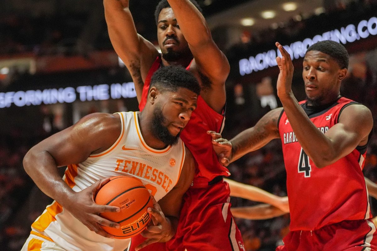 Tennessee forward Jaylen Carey (23) waits for an opportunity to shoot while guarded by Gardner-Webb forward Jacob Hogarth (5) and guard DJ Jefferson (4) during an NCAA college basketball game on Dec. 21, 2025, in Knoxville, Tennessee.