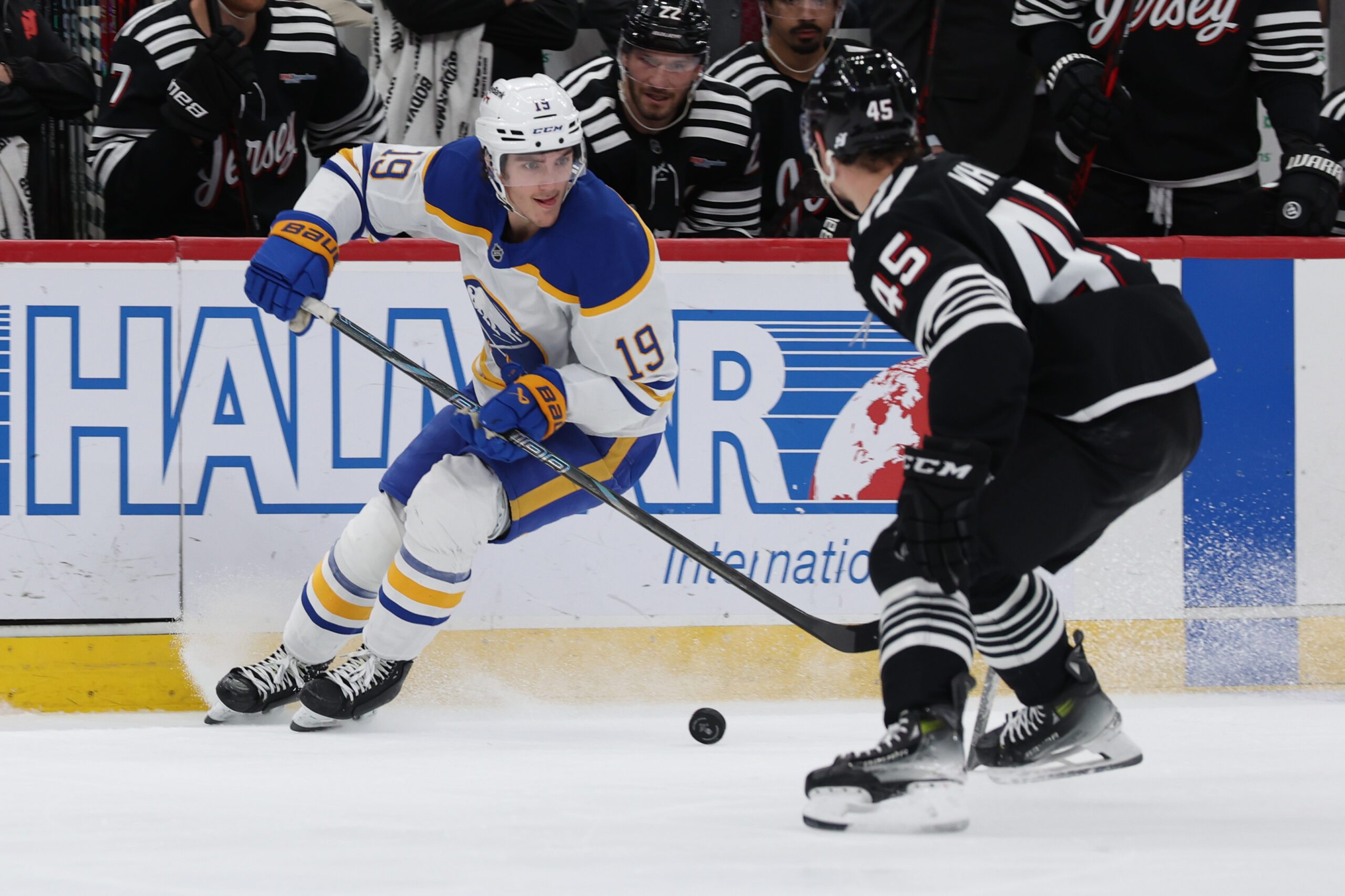 Dec 21, 2025; Newark, New Jersey, USA;   Buffalo Sabres center Peyton Krebs (19) skates past New Jersey Devils defenseman Colton White (45) during the third period at Prudential Center. Mandatory Credit: Thomas Salus-Imagn Images