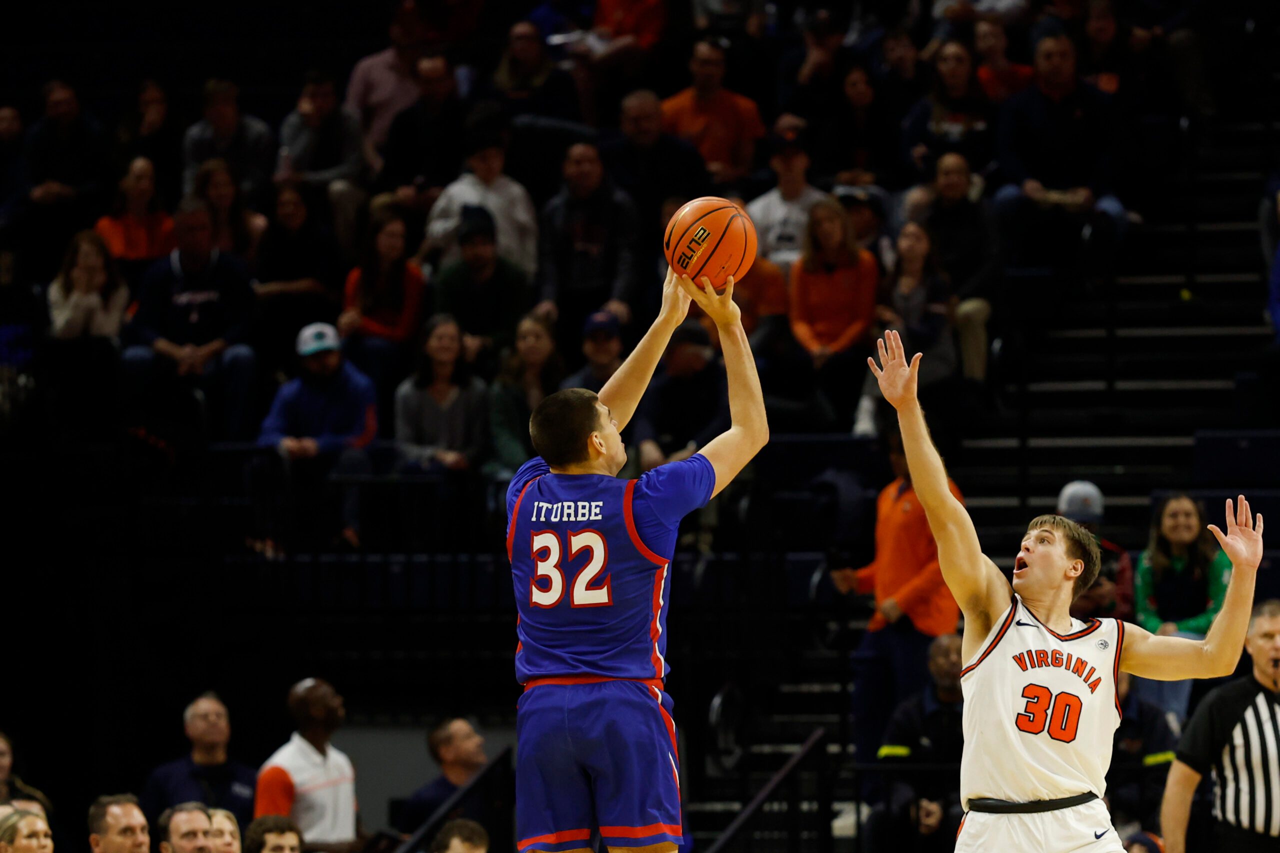 Dec 22, 2025; Charlottesville, Virginia, USA; American University Eagles forward Julen Iturbe (32) shoots the ball over Virginia Cavaliers guard Dallin Hall (30) in the second half at John Paul Jones Arena. Mandatory Credit: Geoff Burke-Imagn Images