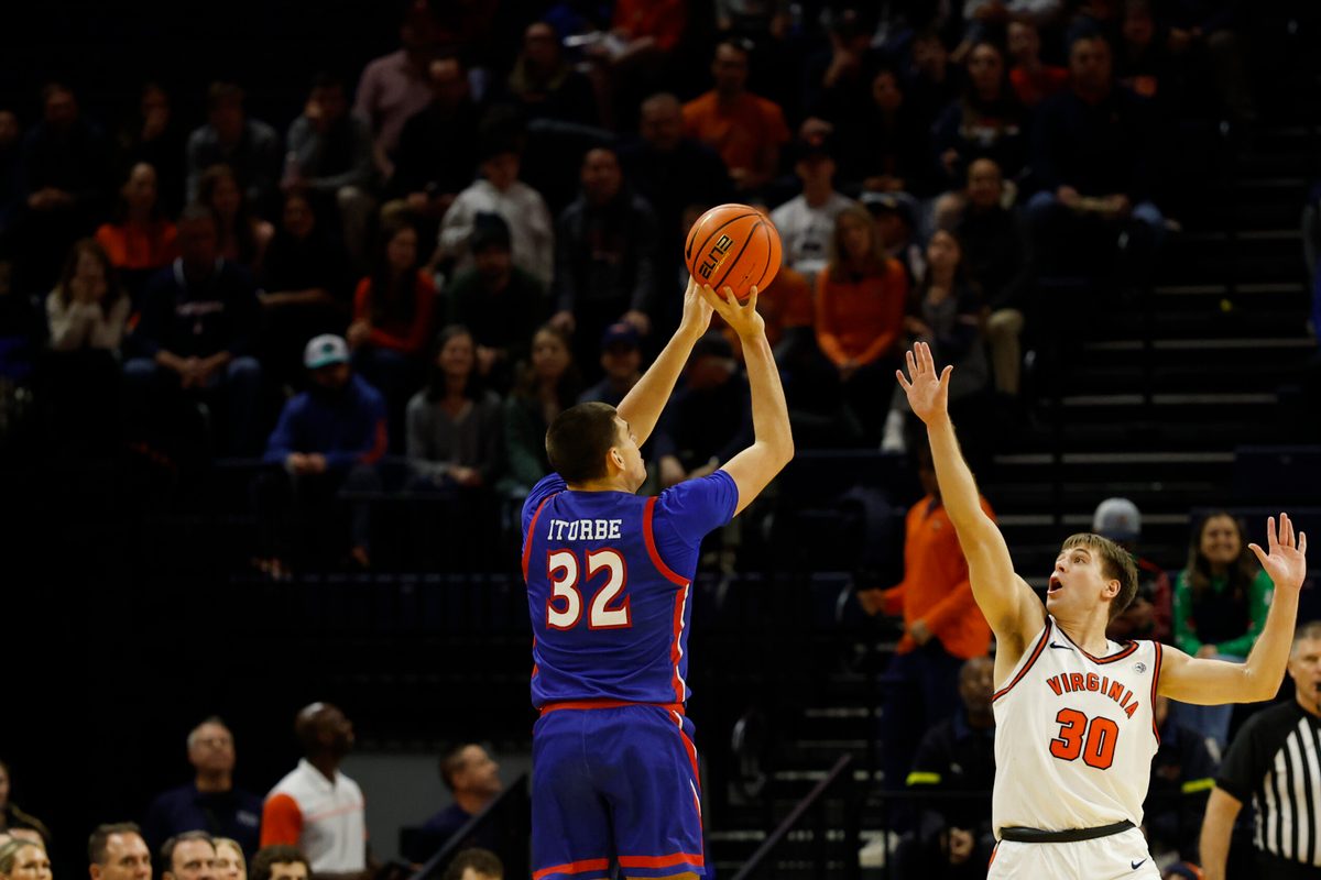 Dec 22, 2025; Charlottesville, Virginia, USA; American University Eagles forward Julen Iturbe (32) shoots the ball over Virginia Cavaliers guard Dallin Hall (30) in the second half at John Paul Jones Arena. Mandatory Credit: Geoff Burke-Imagn Images