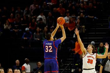 Dec 22, 2025; Charlottesville, Virginia, USA; American University Eagles forward Julen Iturbe (32) shoots the ball over Virginia Cavaliers guard Dallin Hall (30) in the second half at John Paul Jones Arena. Mandatory Credit: Geoff Burke-Imagn Images