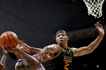 Dec 22, 2025; Bloomington, Indiana, USA; Siena Saints forward Antonio Chandler (2) fouls Indiana Hoosiers forward Nick Dorn (7) during the first half at Simon Skjodt Assembly Hall. Mandatory Credit: Robert Goddin-Imagn Images