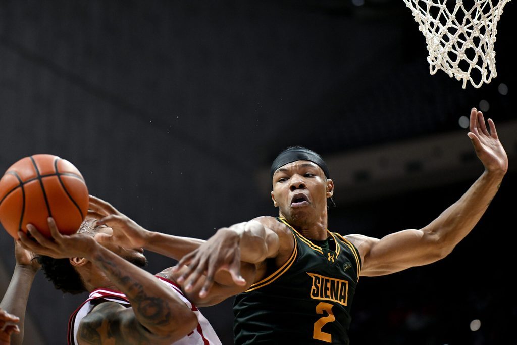 Dec 22, 2025; Bloomington, Indiana, USA; Siena Saints forward Antonio Chandler (2) fouls Indiana Hoosiers forward Nick Dorn (7) during the first half at Simon Skjodt Assembly Hall. Mandatory Credit: Robert Goddin-Imagn Images