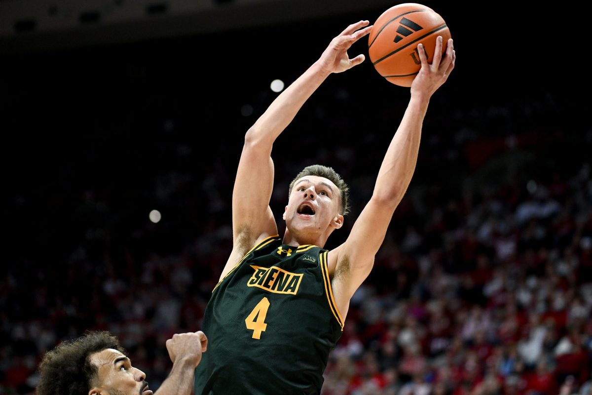 Dec 22, 2025; Bloomington, Indiana, USA; Siena Saints guard Gavin Doty (4) scores past Indiana Hoosiers guard Tayton Conerway (6) during the second half at Simon Skjodt Assembly Hall. Mandatory Credit: Robert Goddin-Imagn Images