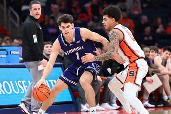 Dec 22, 2025; Syracuse, New York, USA; Stonehill Skyhawks guard Rex Sunderland (1) tries to move past Syracuse Orange guard Naithan George (11) in the second half at the JMA Wireless Dome. Mandatory Credit: Mark Konezny-Imagn Images