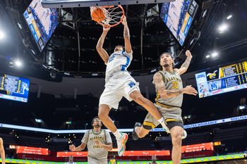 Dec 22, 2025; Memphis, Tennessee, USA; Memphis Tigers forward William Whorton (12) dunks the ball against Alabama State Hornets guard Asjon Anderson (20) during the second half at FedExForum. Mandatory Credit: Wesley Hale-Imagn Images