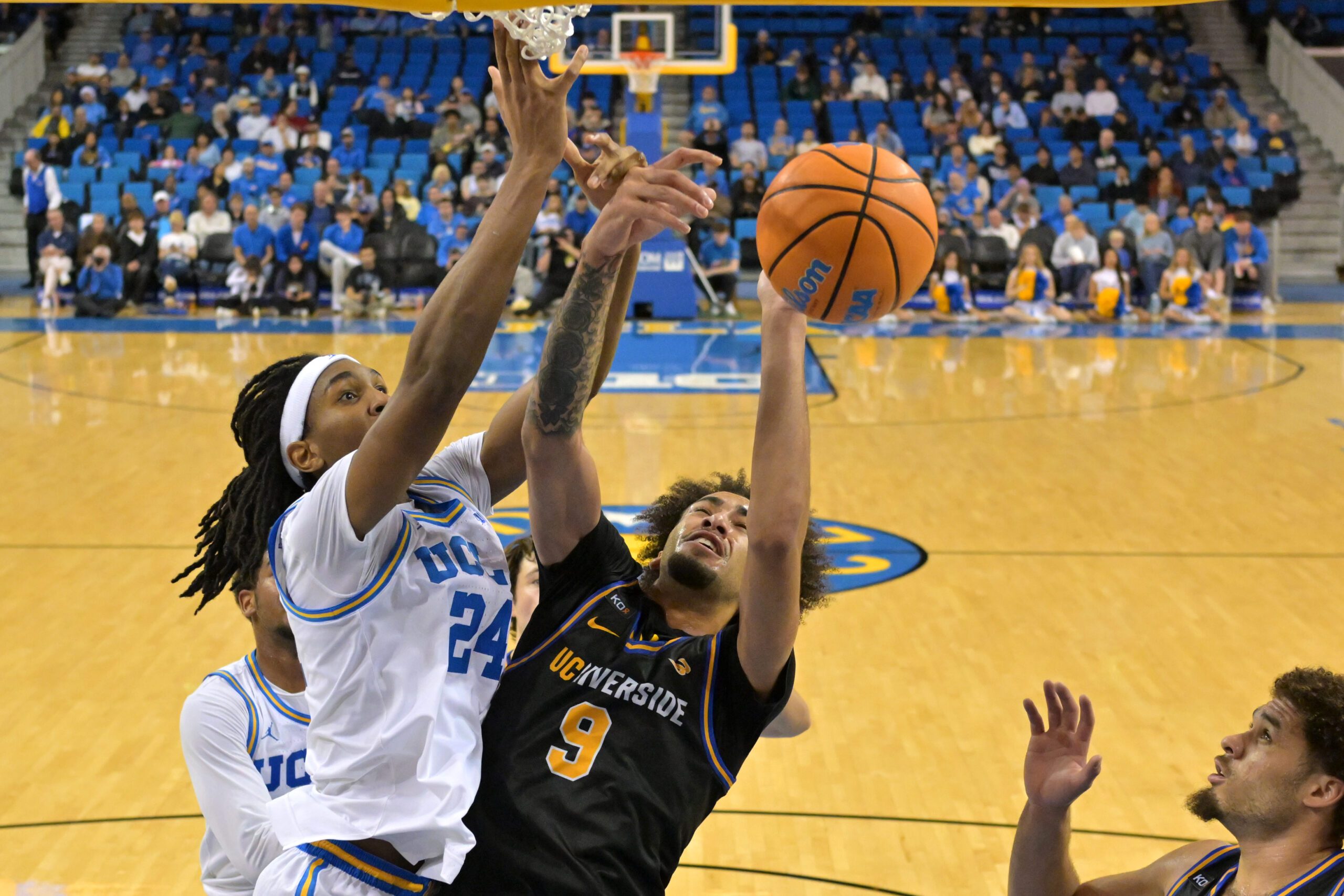 Dec 23, 2025; Los Angeles, California, USA; UCLA Bruins center Steven Jamerson II (24) defends a shot by UC Riverside Highlanders forward Osiris Grady (9) in the second half at Pauley Pavilion presented by Wescom Financial. Mandatory Credit: Jayne Kamin-Oncea-Imagn Images
