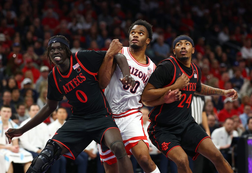 Dec 20, 2025; Phoenix, Arizona, USA; Arizona Wildcats forward Tobe Awaka (30) against San Diego State Aztecs forward Magoon Gwath (0) and guard Taj DeGourville (24) during the Hall of Fame Series at Mortgage Matchup Center. Mandatory Credit: Mark J. Rebilas-Imagn Images
