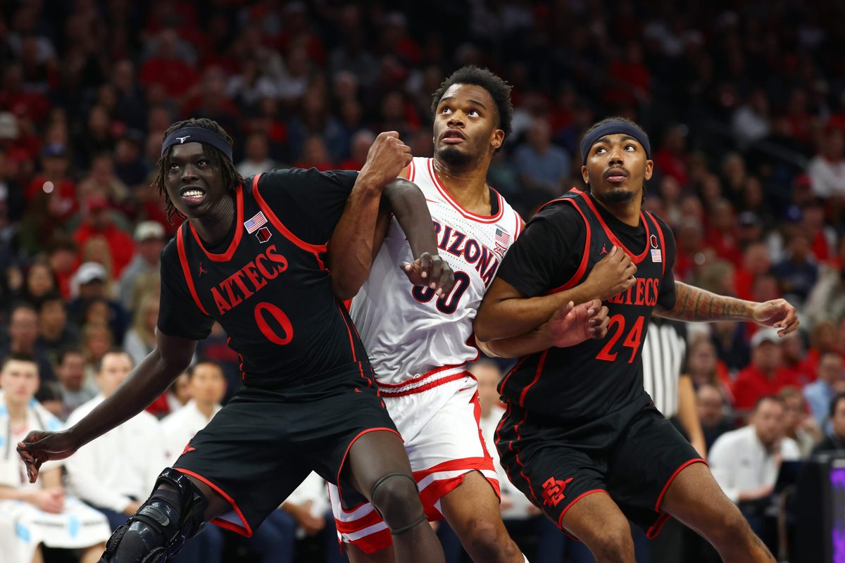 Dec 20, 2025; Phoenix, Arizona, USA; Arizona Wildcats forward Tobe Awaka (30) against San Diego State Aztecs forward Magoon Gwath (0) and guard Taj DeGourville (24) during the Hall of Fame Series at Mortgage Matchup Center. Mandatory Credit: Mark J. Rebilas-Imagn Images