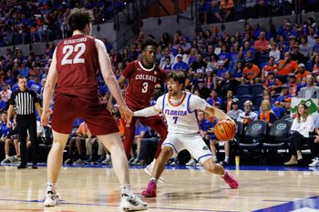 Dec 21, 2025; Gainesville, Florida, USA; Florida Gators guard Urban Klavzar (7) dribbles the ball while Colgate Raiders forward Andrew Alekseyenko (22) and Colgate Raiders guard Jalen Cox (3) defend during the second half at Exactech Arena at the Stephen C. O'Connell Center. Mandatory Credit: Matt Pendleton-Imagn Images