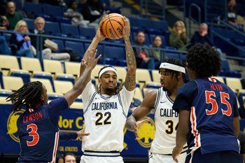 Dec 19, 2025; Berkeley, California, USA; California Golden Bears forward Chris Bell (22) and forward Lee Dort (34) control the ball against Morgan State Bears guard Rob Lawson (3) and forward Eugene Alvin (55) during the first half at Haas Pavilion. Mandatory Credit: Robert Edwards-Imagn Images