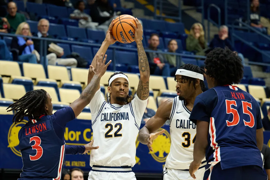 Dec 19, 2025; Berkeley, California, USA; California Golden Bears forward Chris Bell (22) and forward Lee Dort (34) control the ball against Morgan State Bears guard Rob Lawson (3) and forward Eugene Alvin (55) during the first half at Haas Pavilion. Mandatory Credit: Robert Edwards-Imagn Images