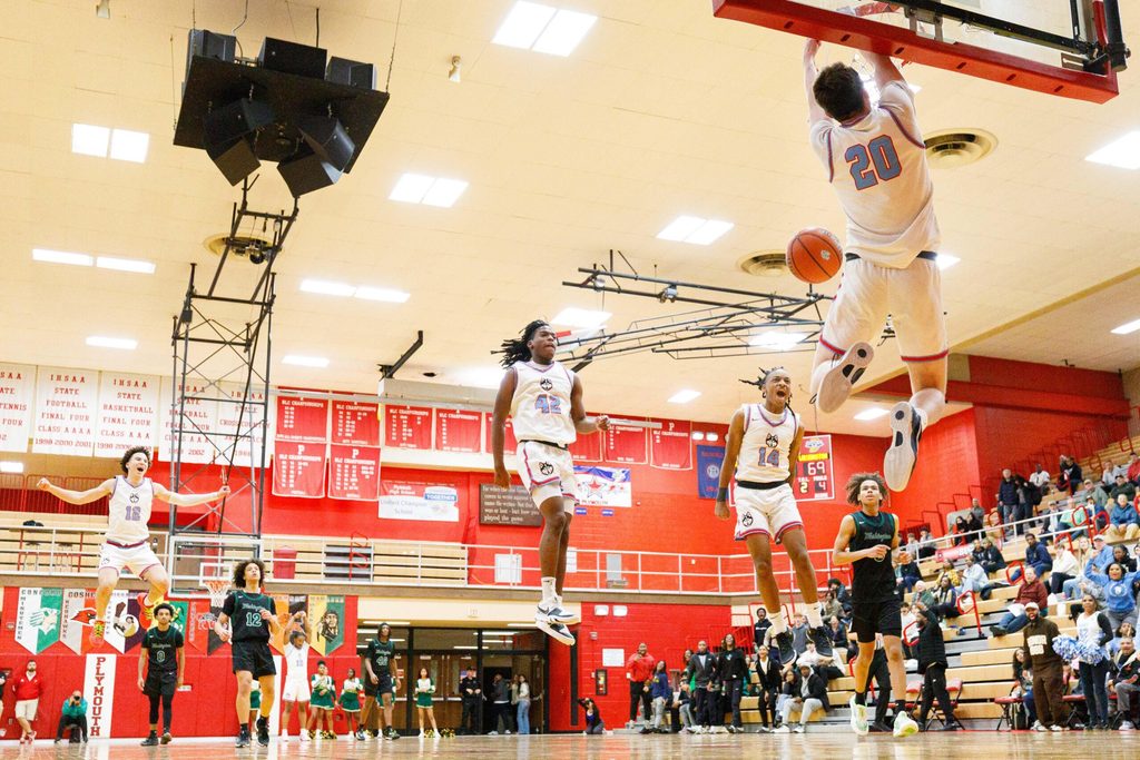 Saint Joseph's Nick Shrewsberry (12), Braylen White (42) and AJ Boone (14) celebrate as Chase Konieczny (20) dunks the ball during an IHSAA 3A Sectional boys basketball game between Saint Joseph and Washington at Plymouth High School on Wednesday, March 5, 2025, in Plymouth.
