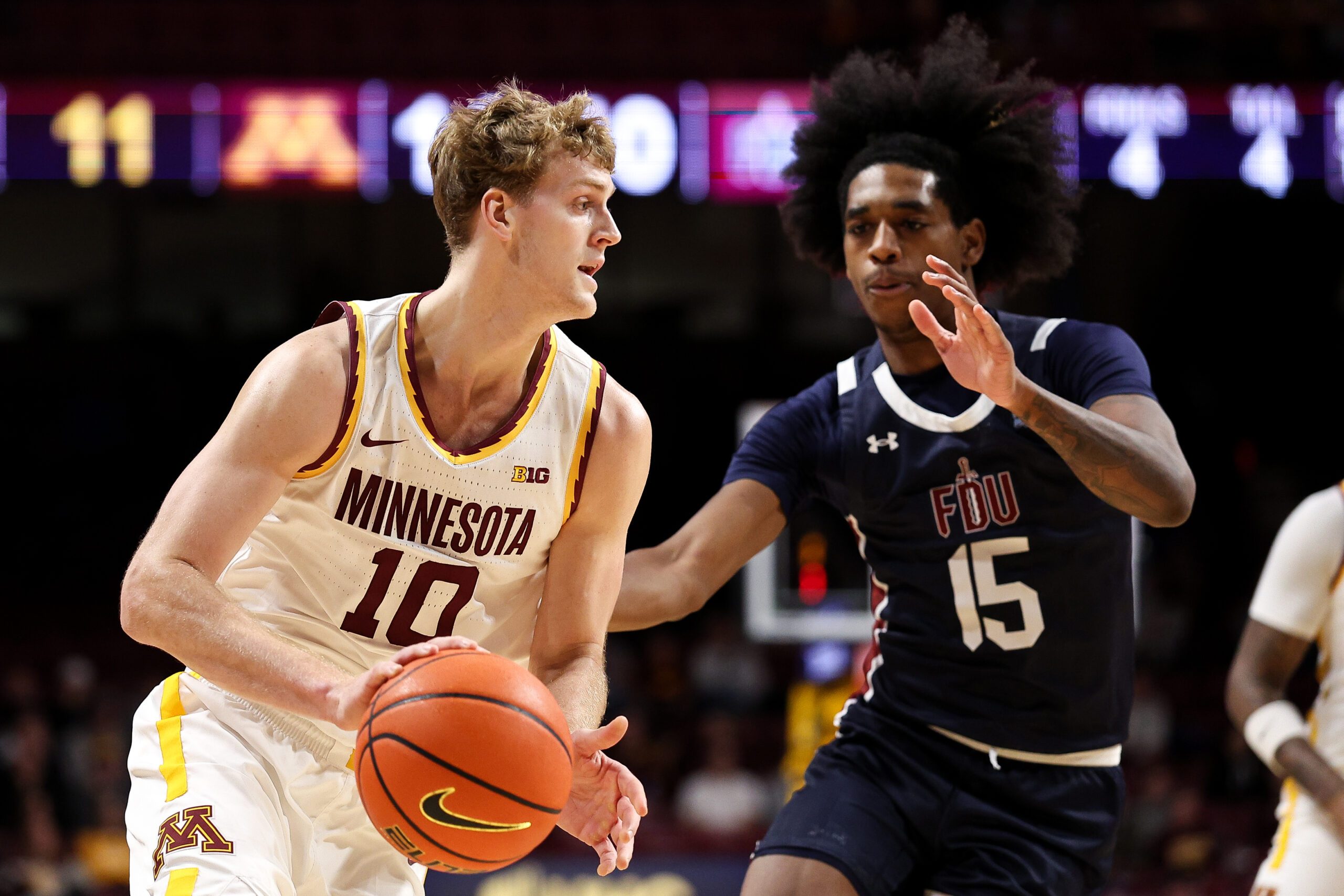 Dec 29, 2025; Minneapolis, Minnesota, USA; Minnesota Golden Gophers forward Cade Tyson (10) works around Fairleigh Dickinson Knights guard Josiah Francis (15) during the first half at Williams Arena. Mandatory Credit: Matt Krohn-Imagn Images