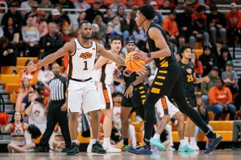 Dec 29, 2025; Stillwater, Oklahoma, USA; Oklahoma State Cowboys guard Kanye Clary (1) guards Bethune-Cookman Wildcats forward Ariel Bland (4) during the second half at Gallagher-Iba Arena. Mandatory Credit: William Purnell-Imagn Images
